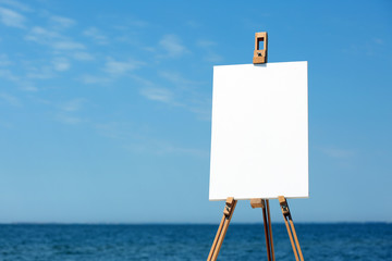 Easel with canvas on beach