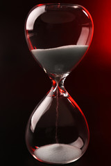 Hourglass on dark red background