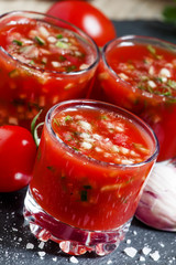 Tomato juice with vegetables and fresh tomato on dark stone back