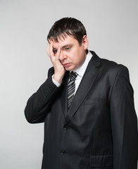 portrait of a young businessman hand covers the face