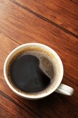 Cup of fresh coffee on wooden background