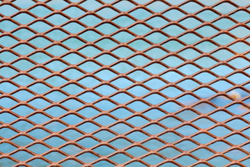 Metal mesh diamond pattern with turquoise water of the Animas river behind