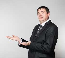 Open palm hand gesture of male hand on dark background