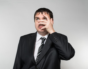 portrait of a young businessman hand covers the face