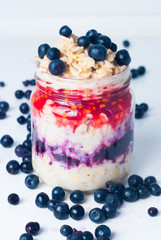 porridge with raspberries and blueberries - obrazy, fototapety, plakaty