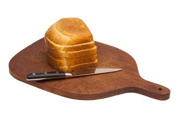 Wooden cutting board with sliced white bread and knife. Isolated