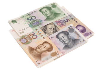 Hundred dollar bill surrounded by Chinese Yuan isolated on white