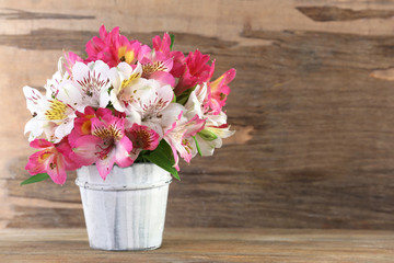 Bouquet of alstroemeria on wooden background