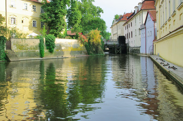 view from the Charles Bridge in the narrow channel in Prague