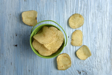 Potato chips on old wooden table