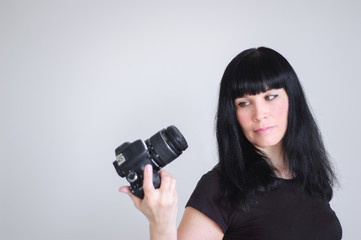 the woman examines the camera