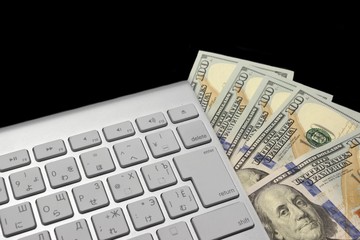 American Dollars Bills And Wireless Keyboard Isolated On Black