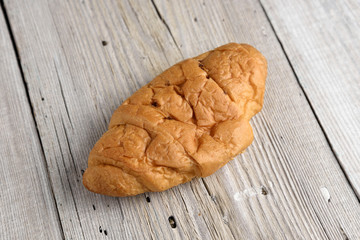 Croissant on old wooden table