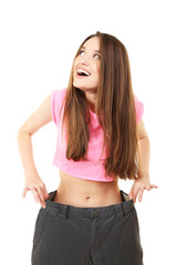 Young slim woman wearing too big pats isolated on white
