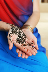 Image of henna on female hands, closeup