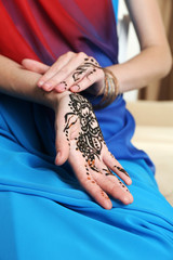 Image of henna on female hands, closeup