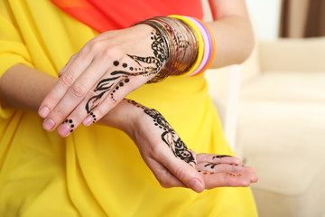 Image of henna on female hands, closeup