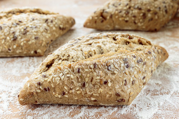 Small Tuscany baguette on a wooden board sprinkled with flour
