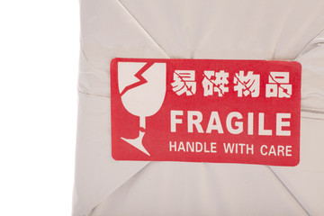 A red "Fragile" sticker on  box