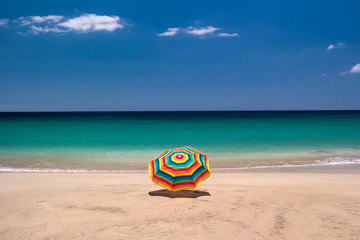 Fototapeta na wymiar Colorful parasol at a beach at Jandia, Fuerteventura