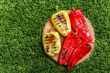 Baked bell peppers grilled on the green grass