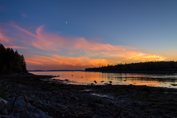 Moon Sunset.  Sunset over Atlantic ocean, Maine, USA, with moon rising