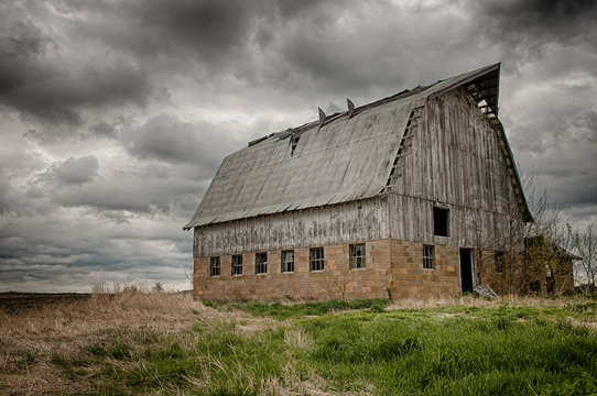 Stormy barn.  Old barn on prairie with stormy sky, USA