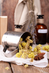 Dried herbs and bottles with tinctures on table close up