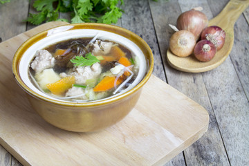 Thai soup recipe in a bowl on wooden