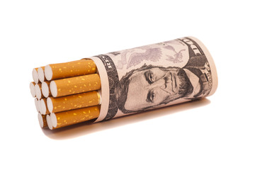 Cigarettes and money on white background