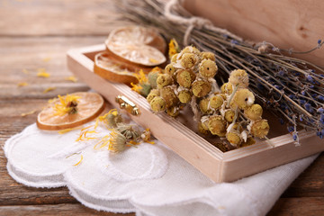 Different dried herbs and lemon on table close up