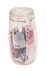 Money jar containing Euro notes isolated on white