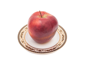 Red apple on plate. Isolated on white background