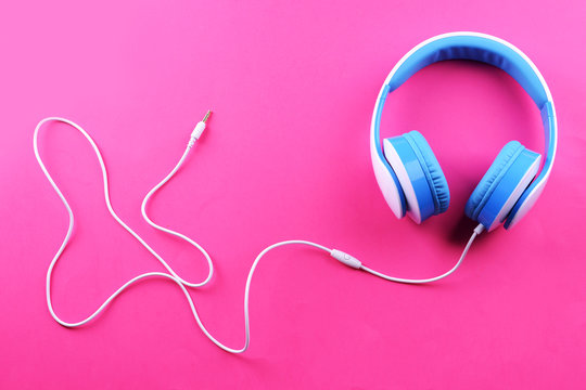 Headphones on pink background