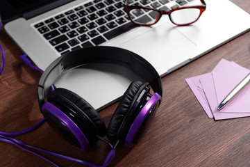 Obraz na płótnie Canvas Workplace with headphones on table close up