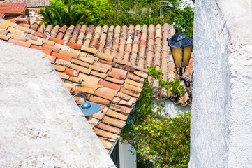 Old tiles on the roofs of houses.