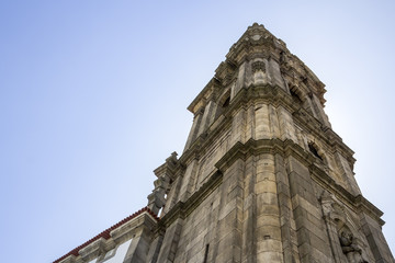 Fototapeta na wymiar Bell tower of the Clerigos Church in blue sky background,