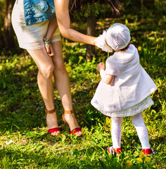 little girl standing in the grass