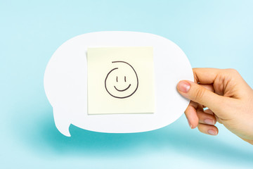 Feedback recognition/prize concept. Happy emoticon on speech bub