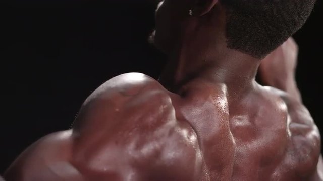 Muscular black man performing a lat pulldown