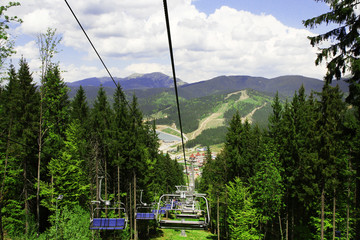 Chairlift over Carpathian mountains background