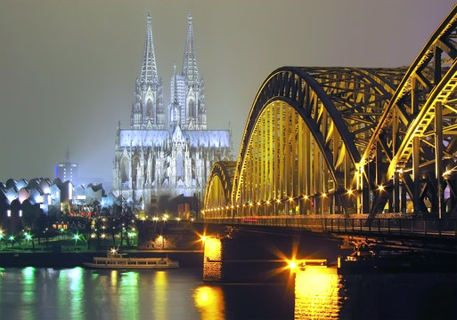 Cologne Cathedral and iron Bridge at night in Cologne, Germany