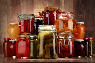 Jars with pickled vegetables and fruity compotes