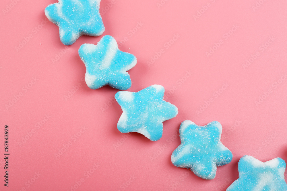 Sticker Blue candies in shape of stars on pink background