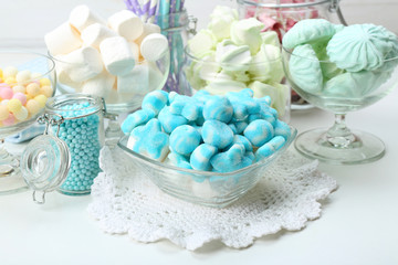 Sweet candies in glassware on table, closeup