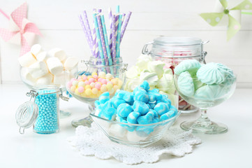 Sweet candies in glassware on table, closeup