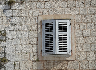 Fototapeta na wymiar Detail of mediterranean architecture - window with shutters, Croatia, Europe