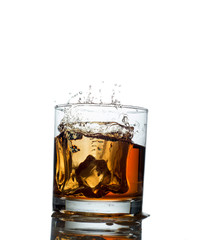 splash of whiskey with ice osolated on white