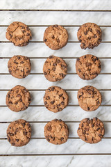 Homemade chocolate cookies over white marble background