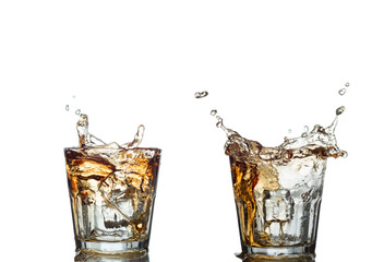 splash of whiskey with ice osolated on white